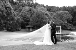 Couple facing each other as the veil floats in the air – Brisbane Wedding Photographer